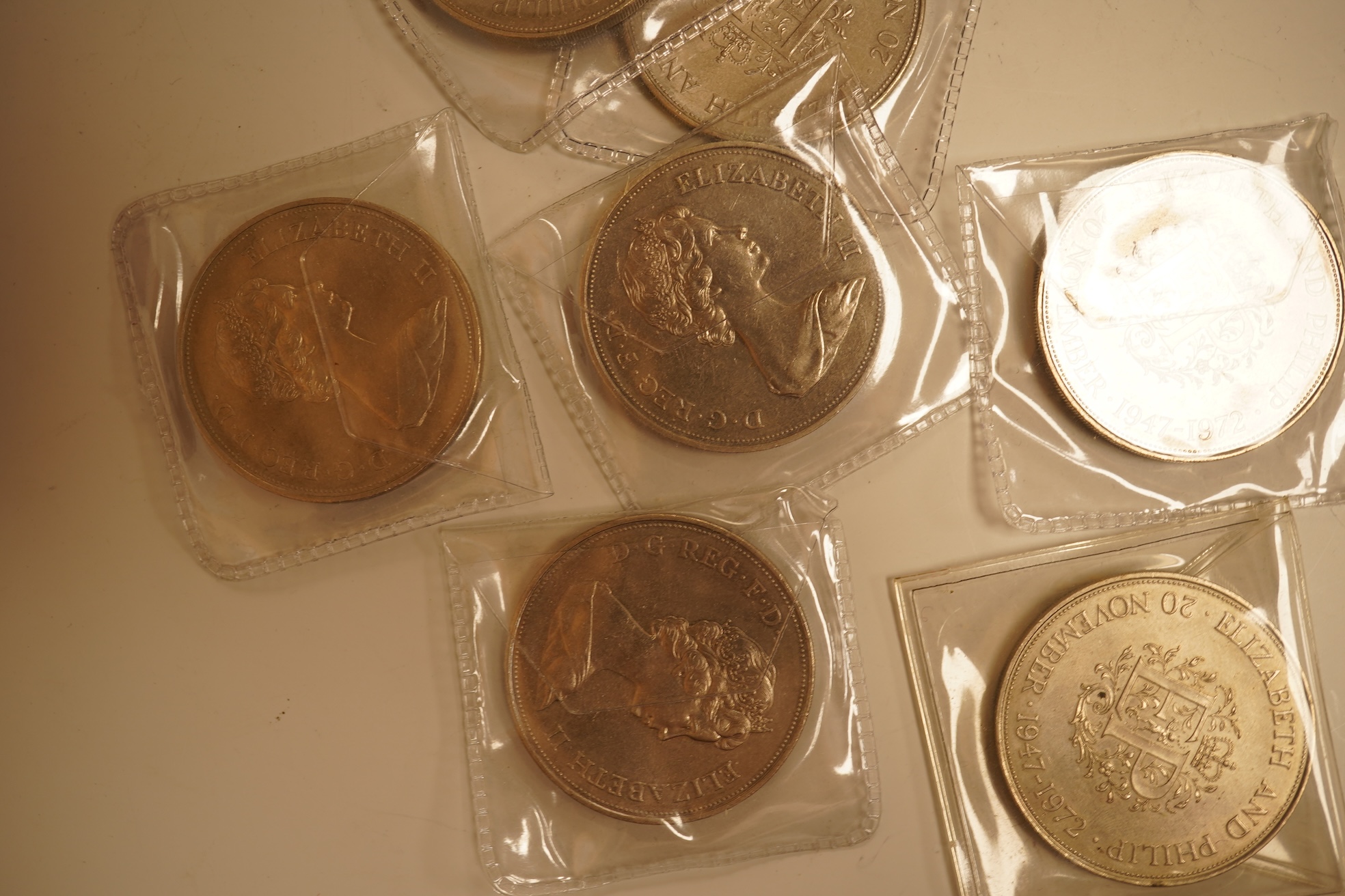 A collection of coins, notes and wrist watches